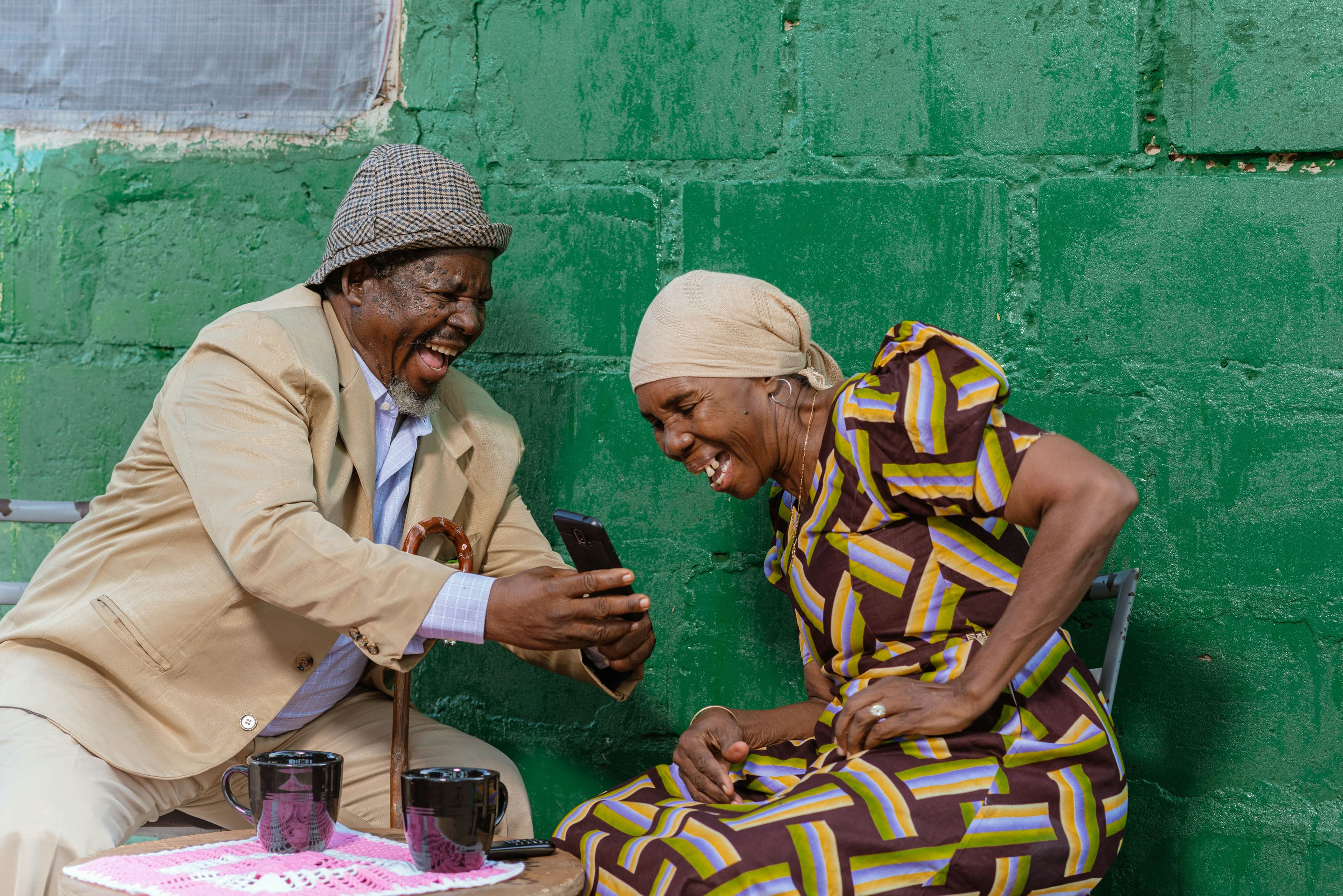 Couple laughing together with phone in hand
