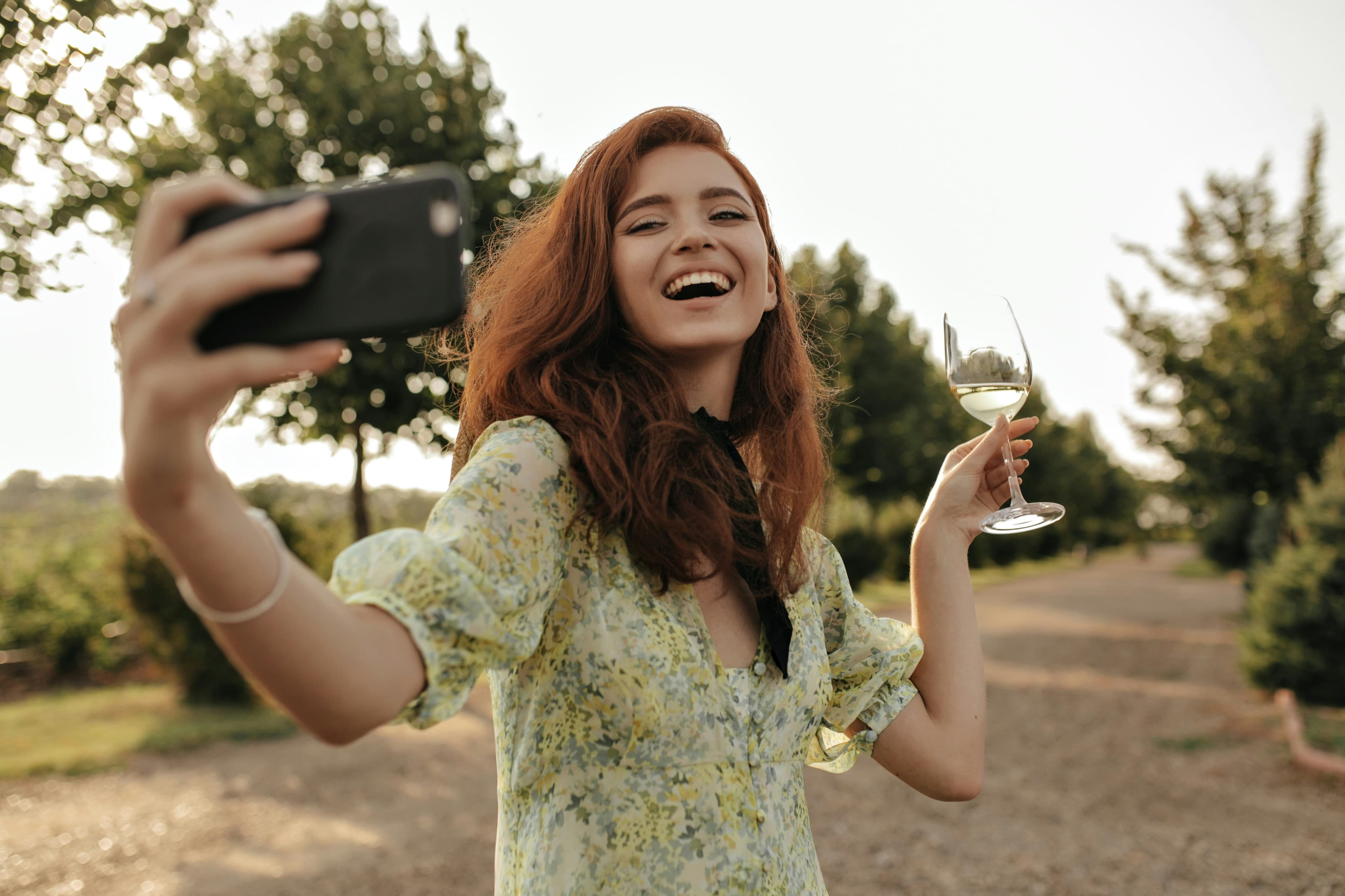Woman taking a selfie with a wine glass